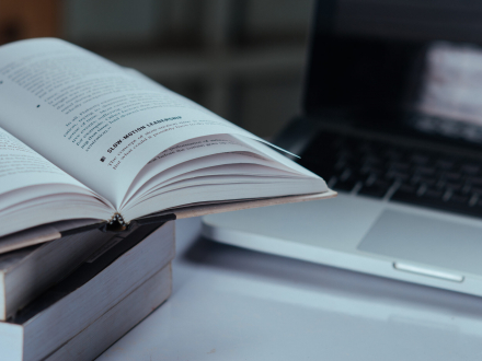 education concept, books and laptop at library